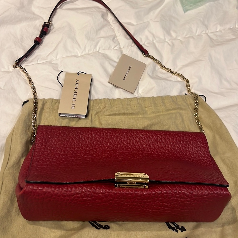 Red Burberry shoulder bag with gold hardware, perfect for an evening dinner!